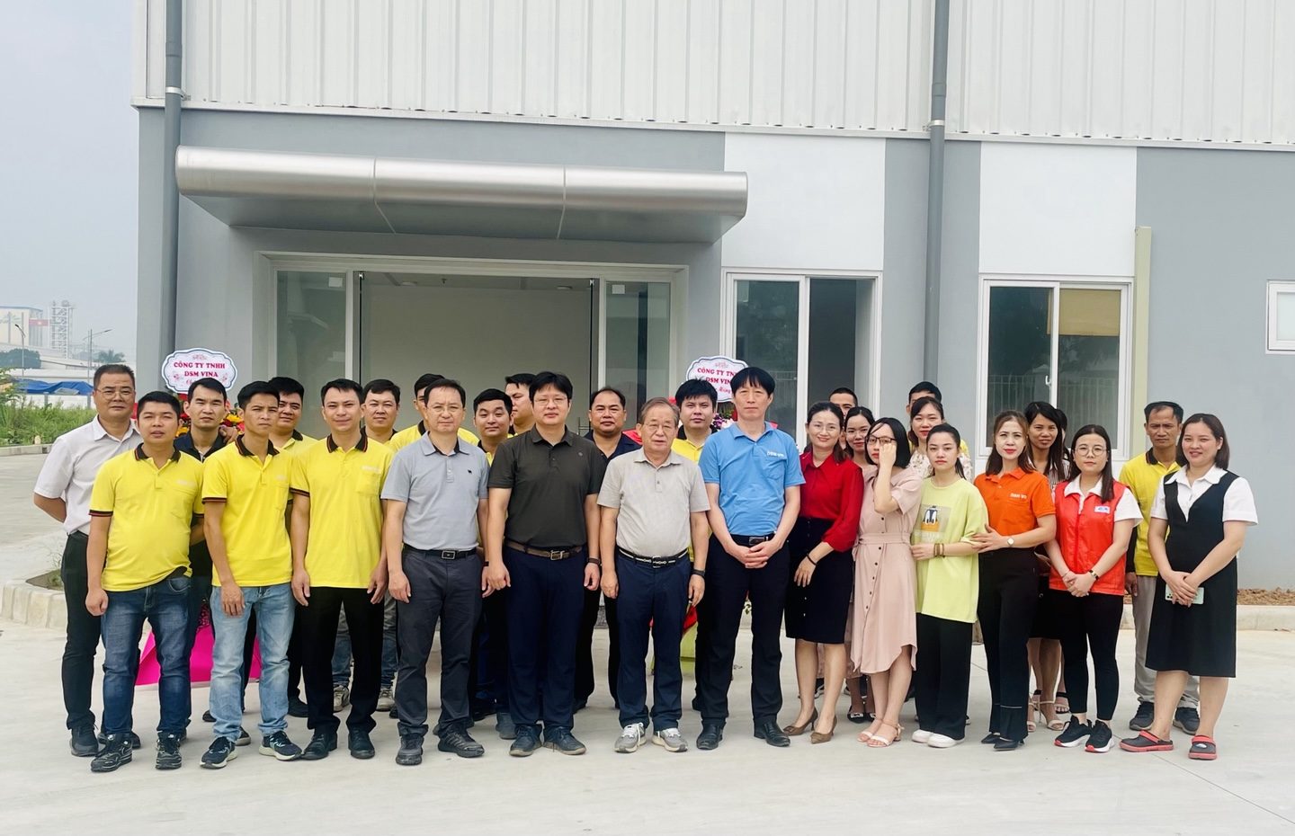 Employees in front of the plant
